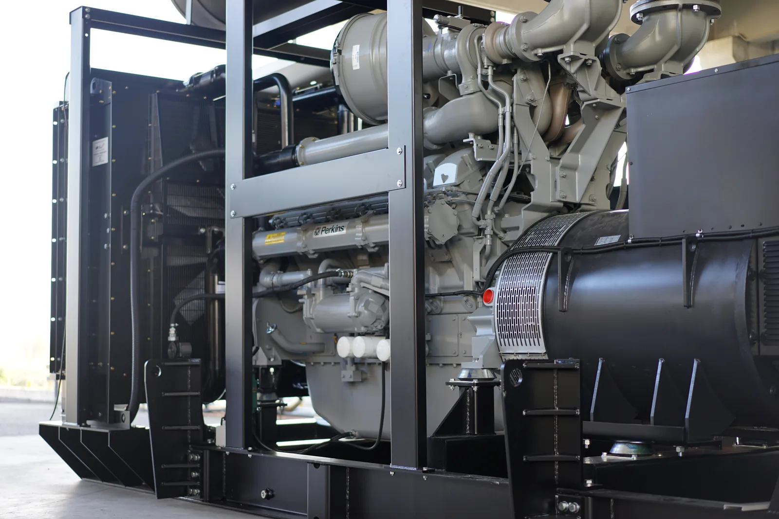 Large open Perkins generator set with V-engine, alternator and radiator on a steel base frame